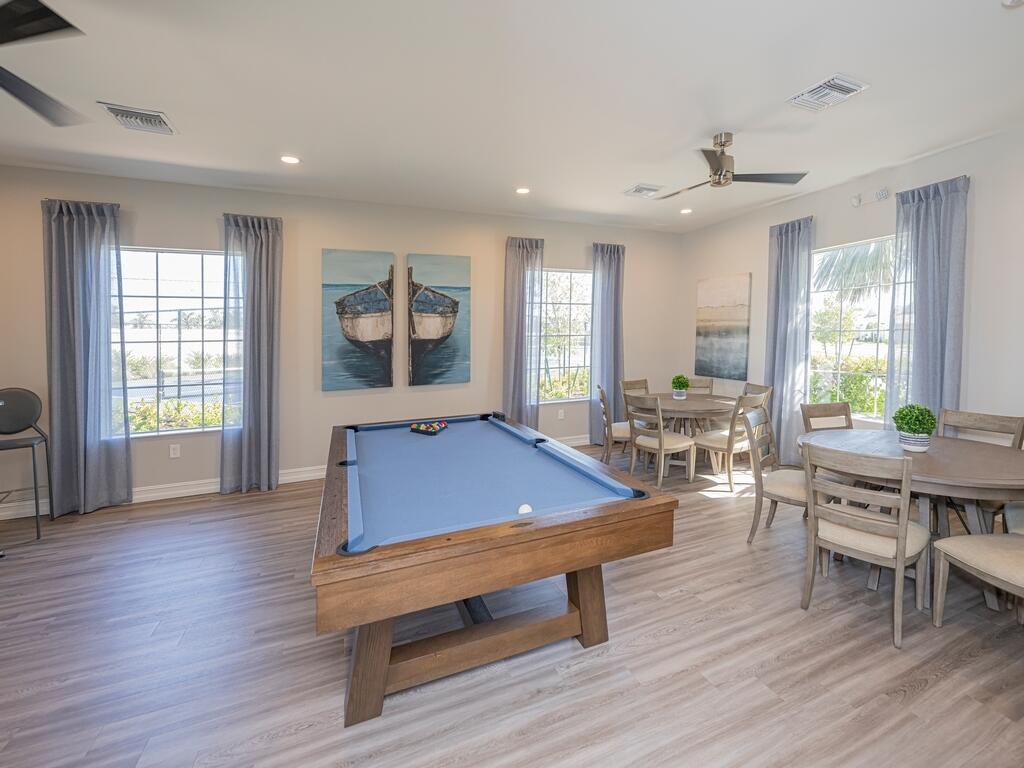 1087 Rolling Brk Lane Naples, FL 34114 - Photo 32 of 33 a room with wooden floor pool table and windows
