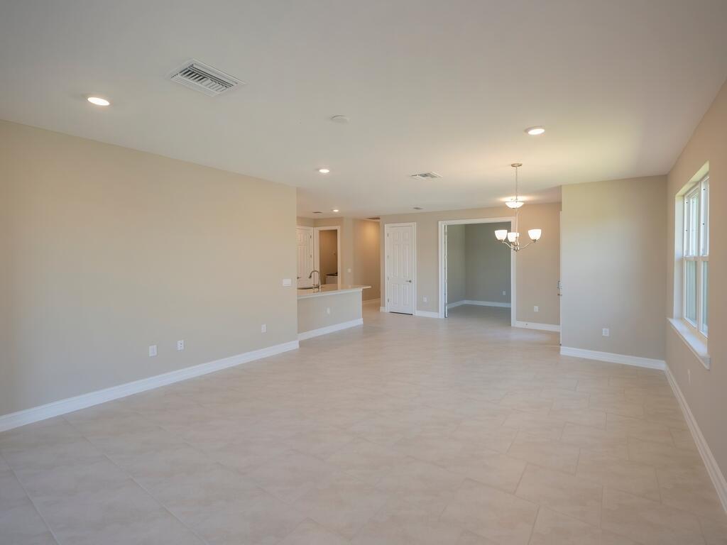 1087 Rolling Brk Lane Naples, FL 34114 - Photo 5 of 33 an empty room with window and pillar in it