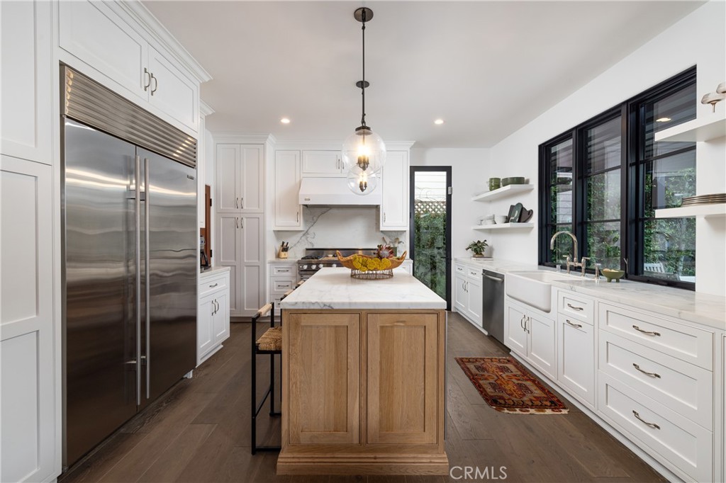 419 Signal Road Newport Beach, CA 92663 - Photo 11 of 32 a kitchen with kitchen island a counter top space a sink stainless steel appliances and cabinets
