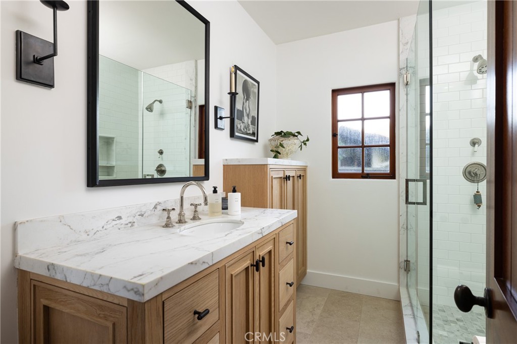 419 Signal Road Newport Beach, CA 92663 - Photo 13 of 32 a bathroom with a sink a mirror and a shower