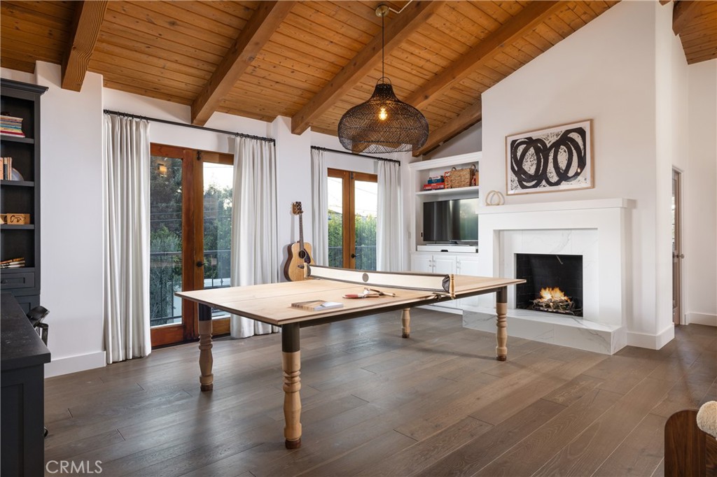 419 Signal Road Newport Beach, CA 92663 - Photo 16 of 32 a dining room with furniture a fireplace and wooden floor