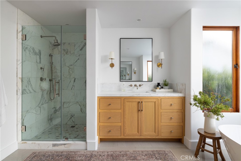 419 Signal Road Newport Beach, CA 92663 - Photo 22 of 32 a bathroom with a granite countertop sink a mirror a shower and a mirror