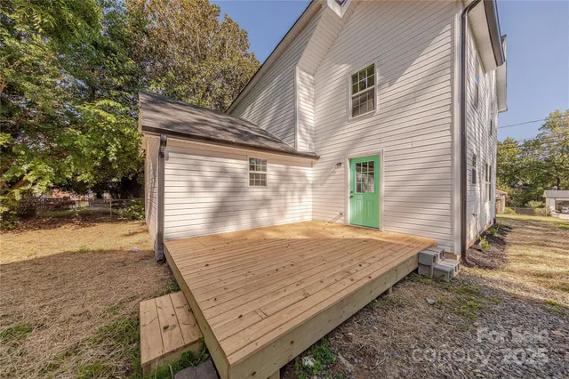 a view of backyard with wooden deck