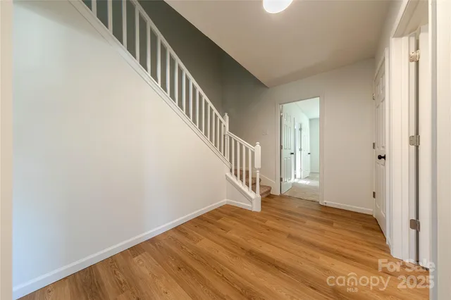 a view of an entryway with wooden floor