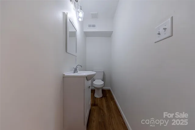 a bathroom with a sink a toilet and mirror