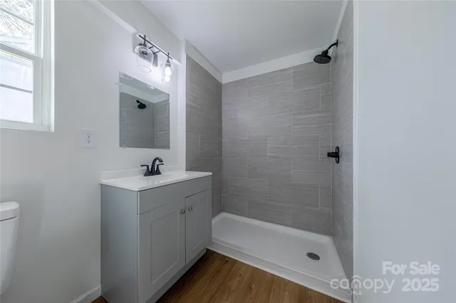 a bathroom with a tub sink and mirror