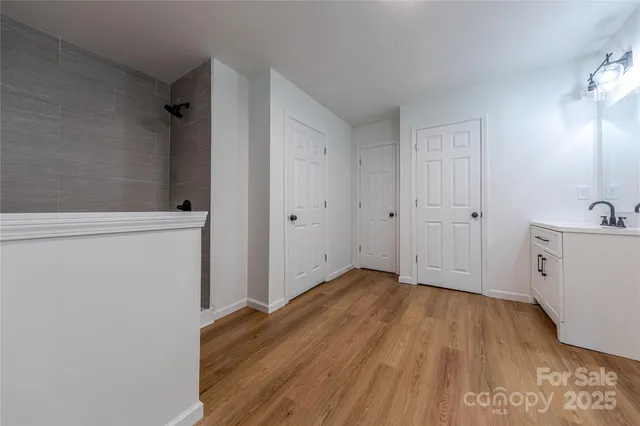 a view of a room with wooden floor