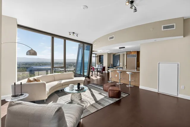 a living room with furniture or couch and a floor to ceiling window