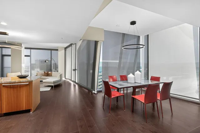 a room with furniture and large windows