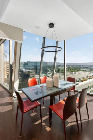 a dining room with furniture window and wooden floor