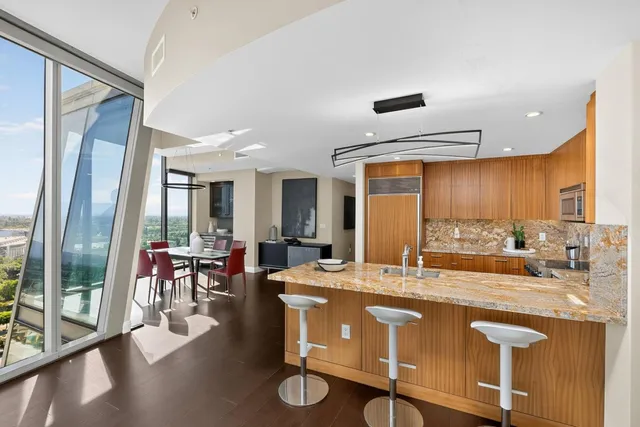 a kitchen with stainless steel appliances granite countertop a stove a sink dishwasher and a refrigerator