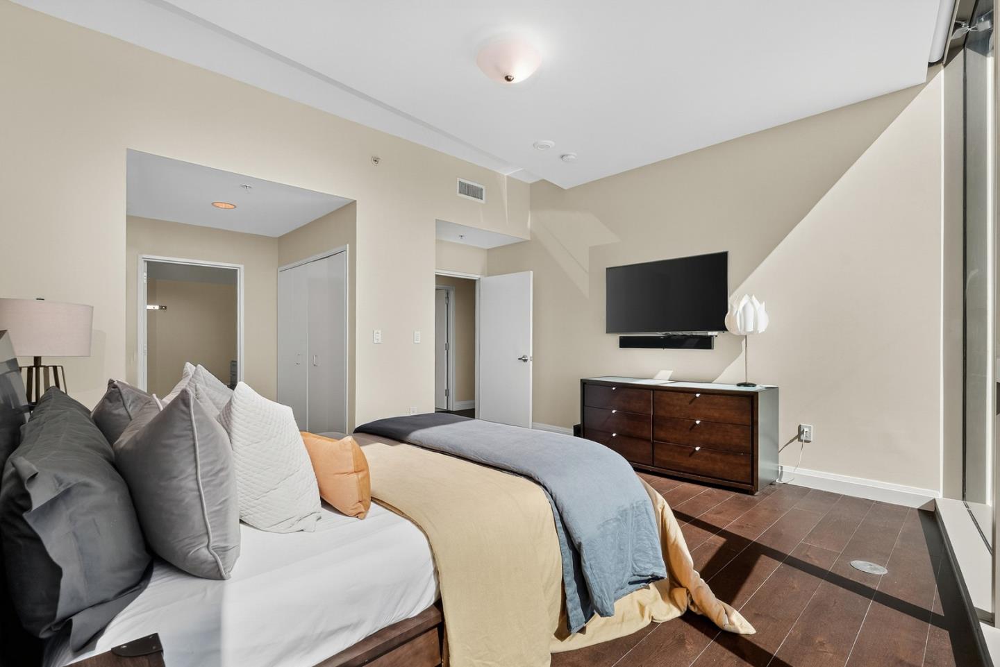 38 North Almaden Boulevard, Unit 2001 San Jose, CA 95110 - Photo 32 of 44 a bedroom with a bed and a flat screen tv