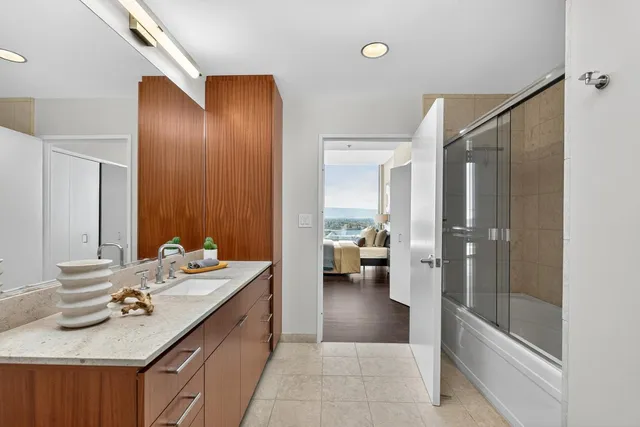 a bathroom that has a glass shower door