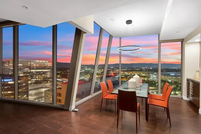 a living room with furniture city view and large windows