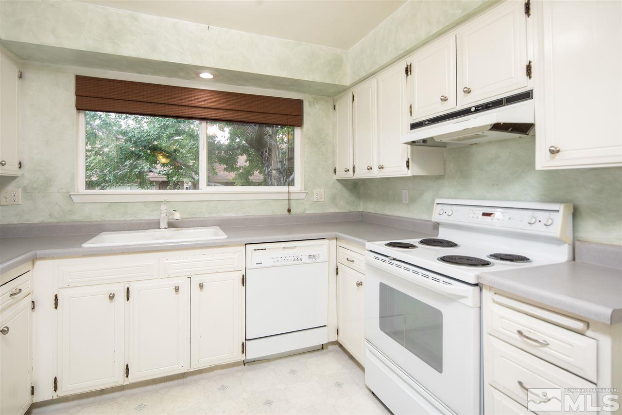 3375 Lookout Place Reno, NV 89503 - Photo 19 of 25 a kitchen with granite countertop white cabinets and white appliances