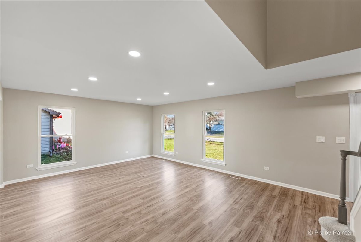 2004 Clematis Drive Algonquin, IL 60102 - Photo 16 of 44 an empty room with wooden floor and windows