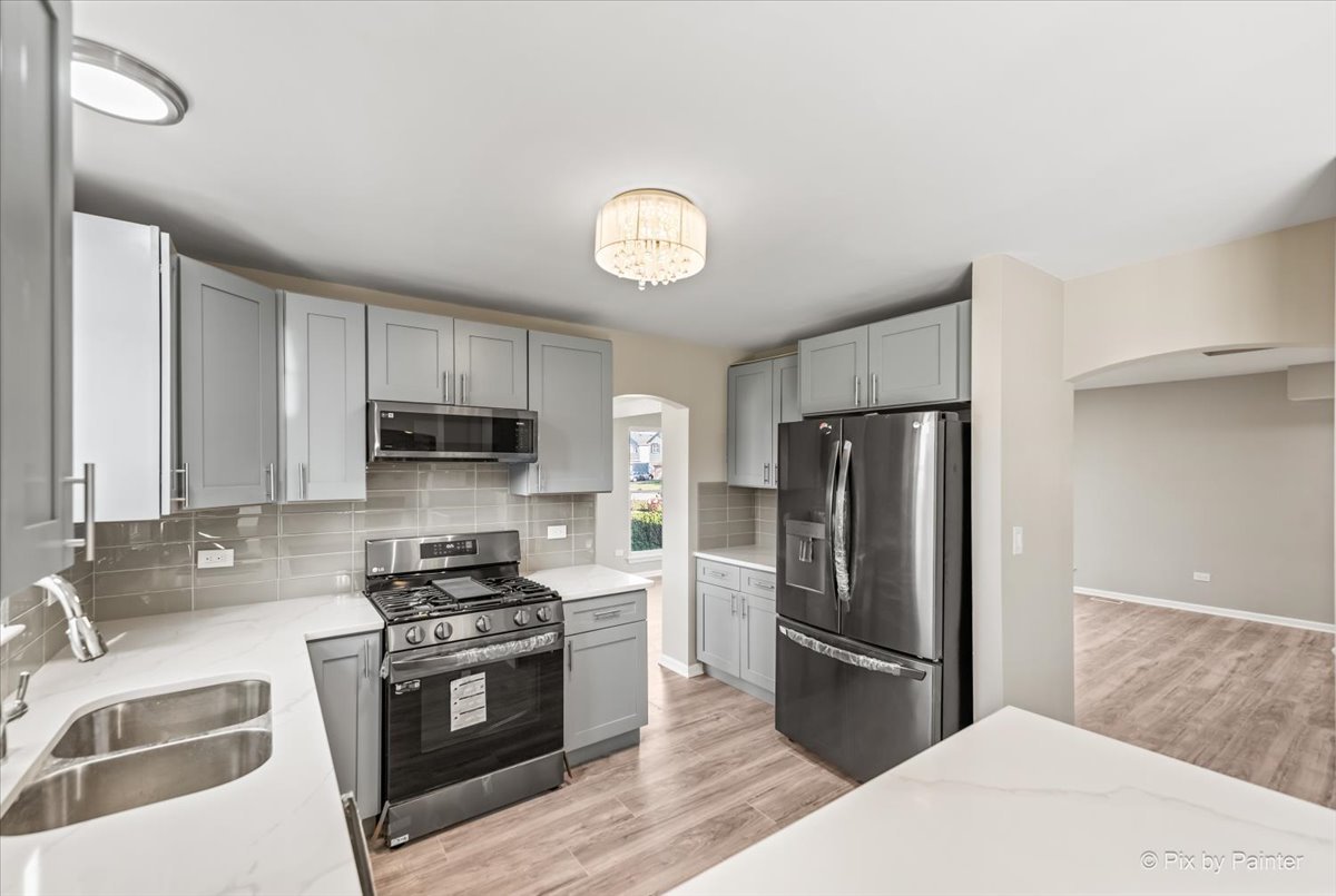 2004 Clematis Drive Algonquin, IL 60102 - Photo 18 of 44 a kitchen with stainless steel appliances granite countertop a refrigerator a stove a sink and a microwave