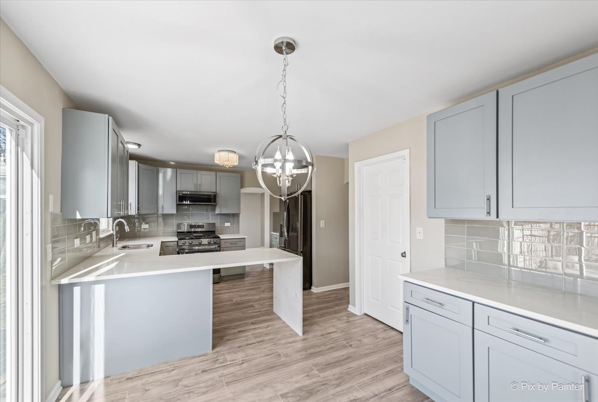 2004 Clematis Drive Algonquin, IL 60102 - Photo 20 of 44 a kitchen with stainless steel appliances granite countertop a sink stove and refrigerator