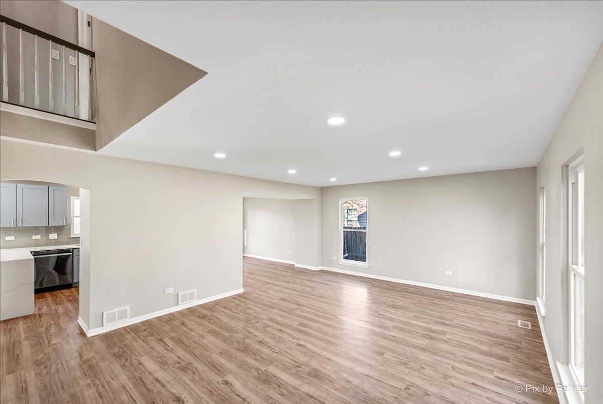 2004 Clematis Drive Algonquin, IL 60102 - Photo 2 of 44 a view of an empty room with wooden floor and a kitchen
