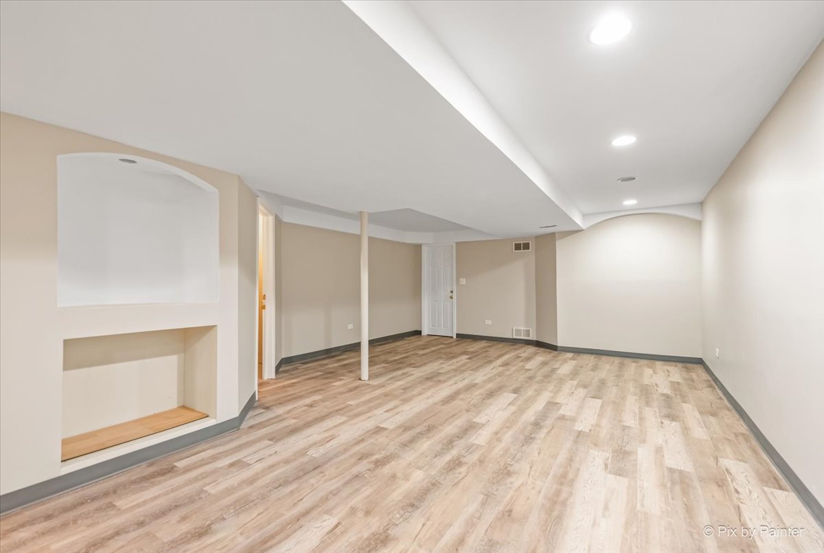 2004 Clematis Drive Algonquin, IL 60102 - Photo 37 of 44 wooden floor in an empty room with a fireplace