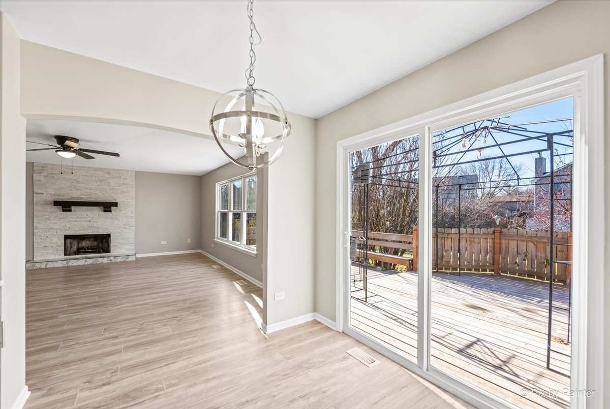 2004 Clematis Drive Algonquin, IL 60102 - Photo 5 of 44 a view of a livingroom with a fireplace a chandelier and wooden floor
