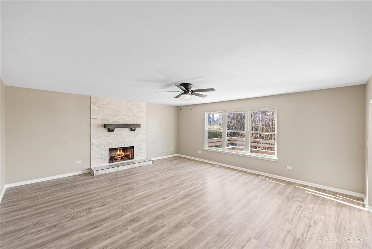 2004 Clematis Drive Algonquin, IL 60102 - Photo 6 of 44 an empty room with wooden floor ceiling fan and windows