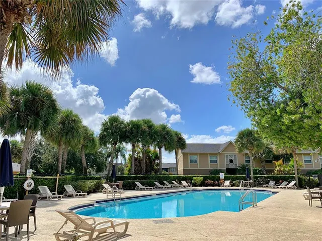 a view of a house with swimming pool and a yard