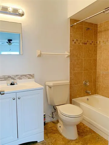 a bathroom with a sink a toilet and bathtub