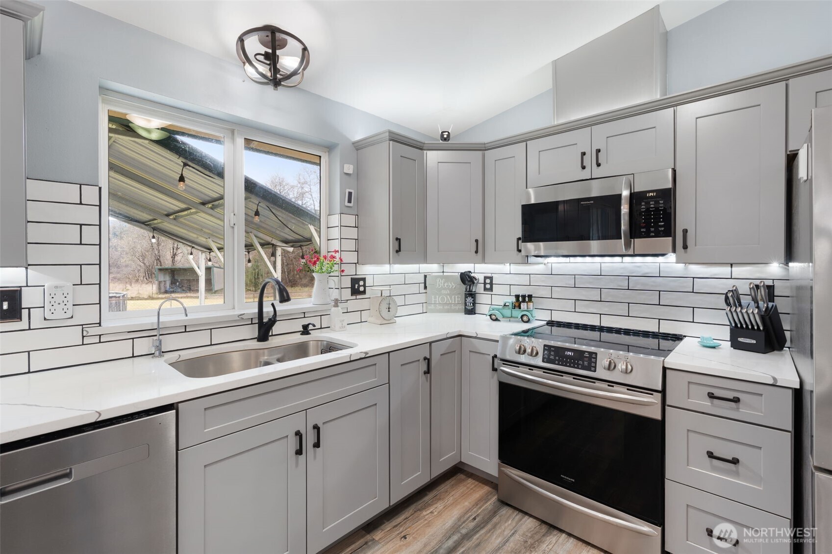 453 Coma Road Vader, WA 98593 - Photo 12 of 40 a kitchen with a sink stove oven and microwave