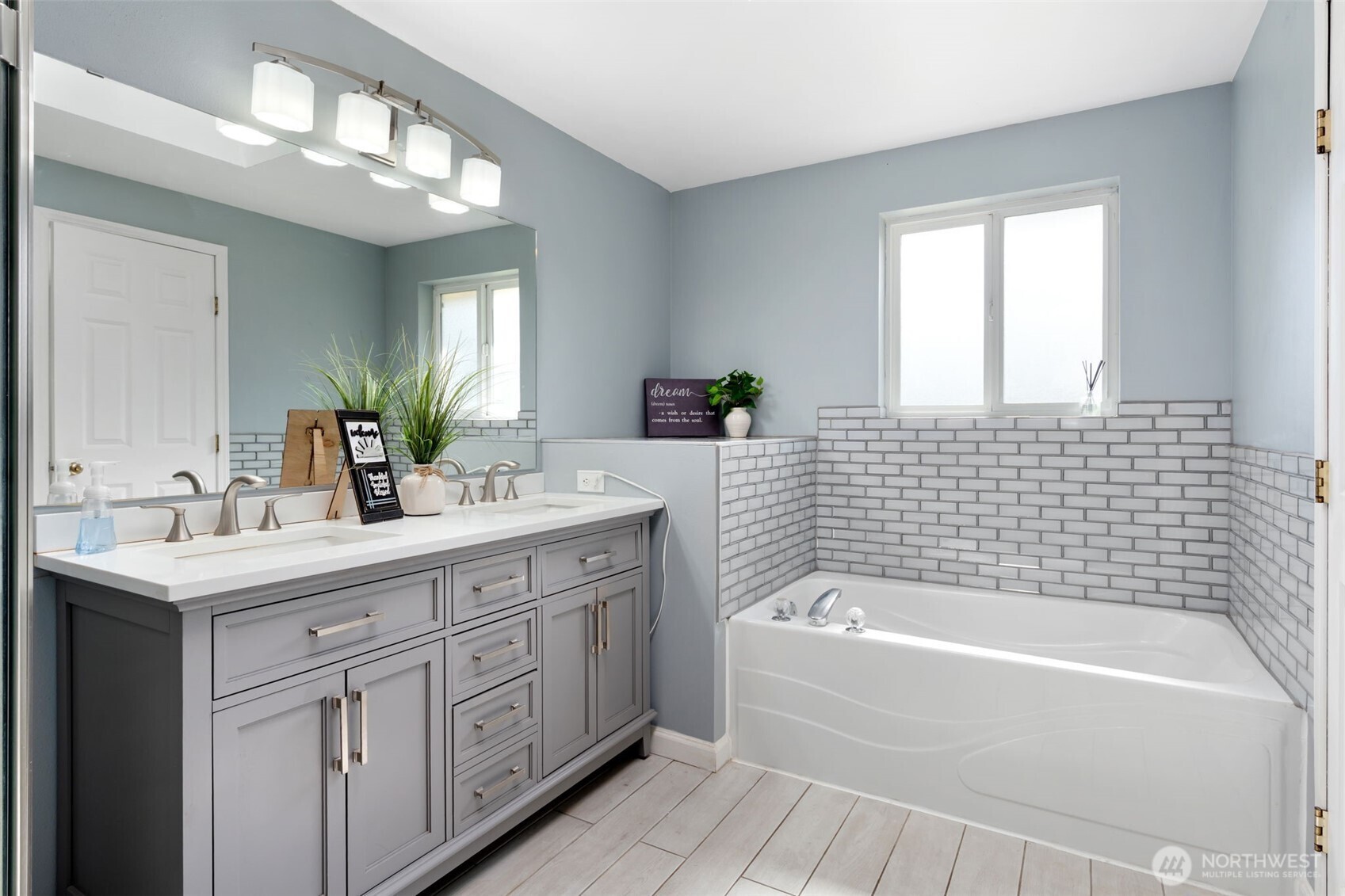 453 Coma Road Vader, WA 98593 - Photo 19 of 40 a bathroom with a tub a sink double vanity and a mirror