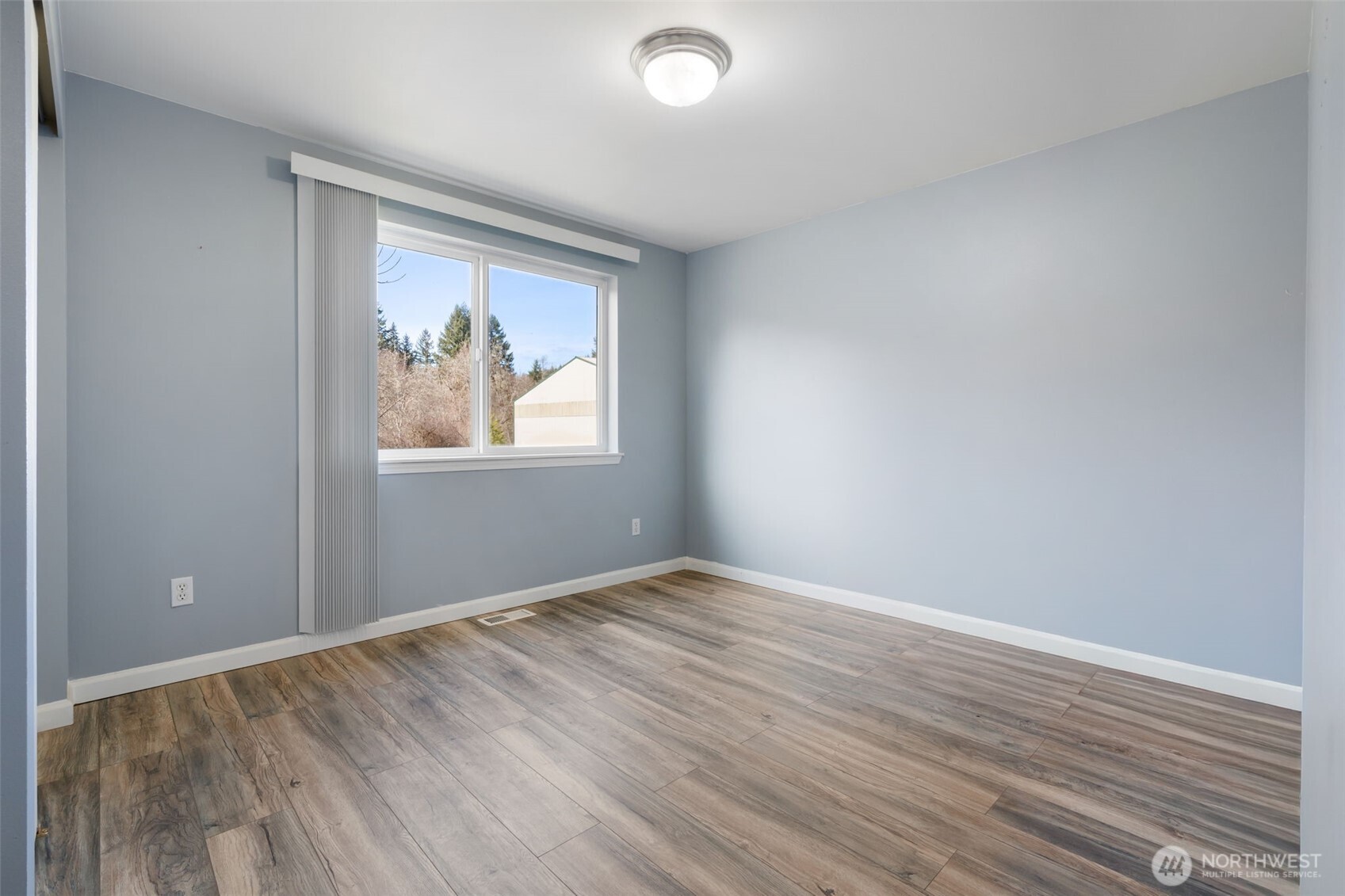 453 Coma Road Vader, WA 98593 - Photo 20 of 40 an empty room with wooden floor and windows