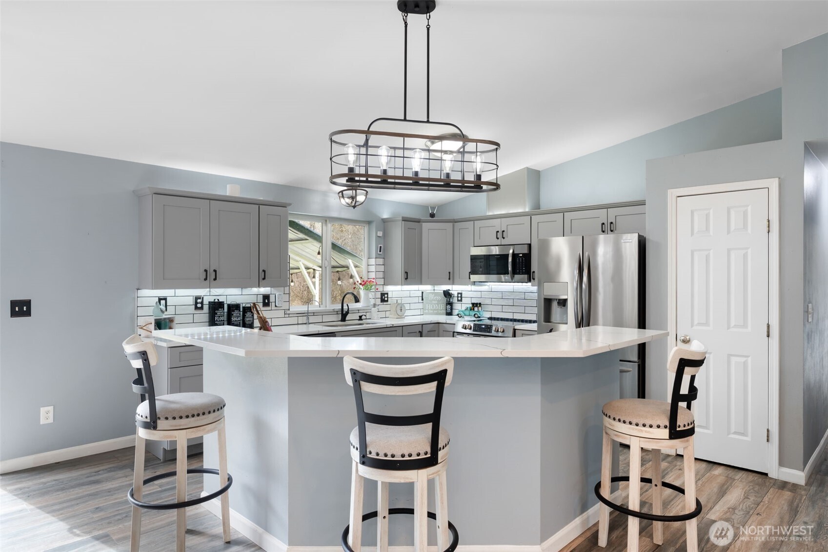 453 Coma Road Vader, WA 98593 - Photo 10 of 40 a kitchen with stainless steel appliances granite countertop a dining table chairs and white cabinets
