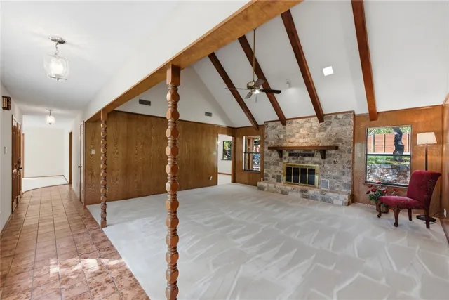 a view of a hallway with furniture and chandelier