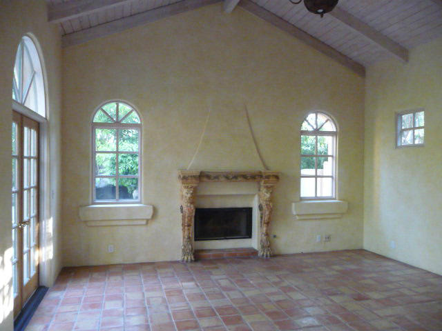 1845 Eucalyptus Hill Road Santa Barbara, CA 93108 - Photo 5 of 13 an empty room with windows fireplace and fans