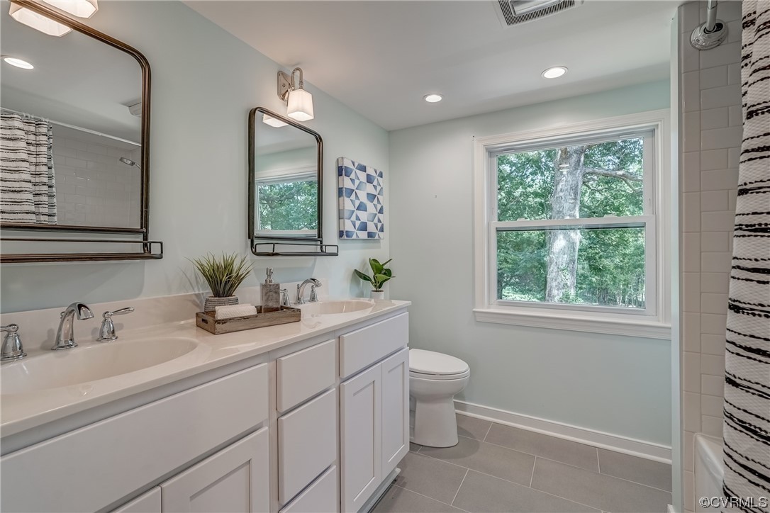 1289 Shallow Well Road Manakin-Sabot, VA 23103 - Photo 29 of 50 a bathroom with a toilet sink and mirror