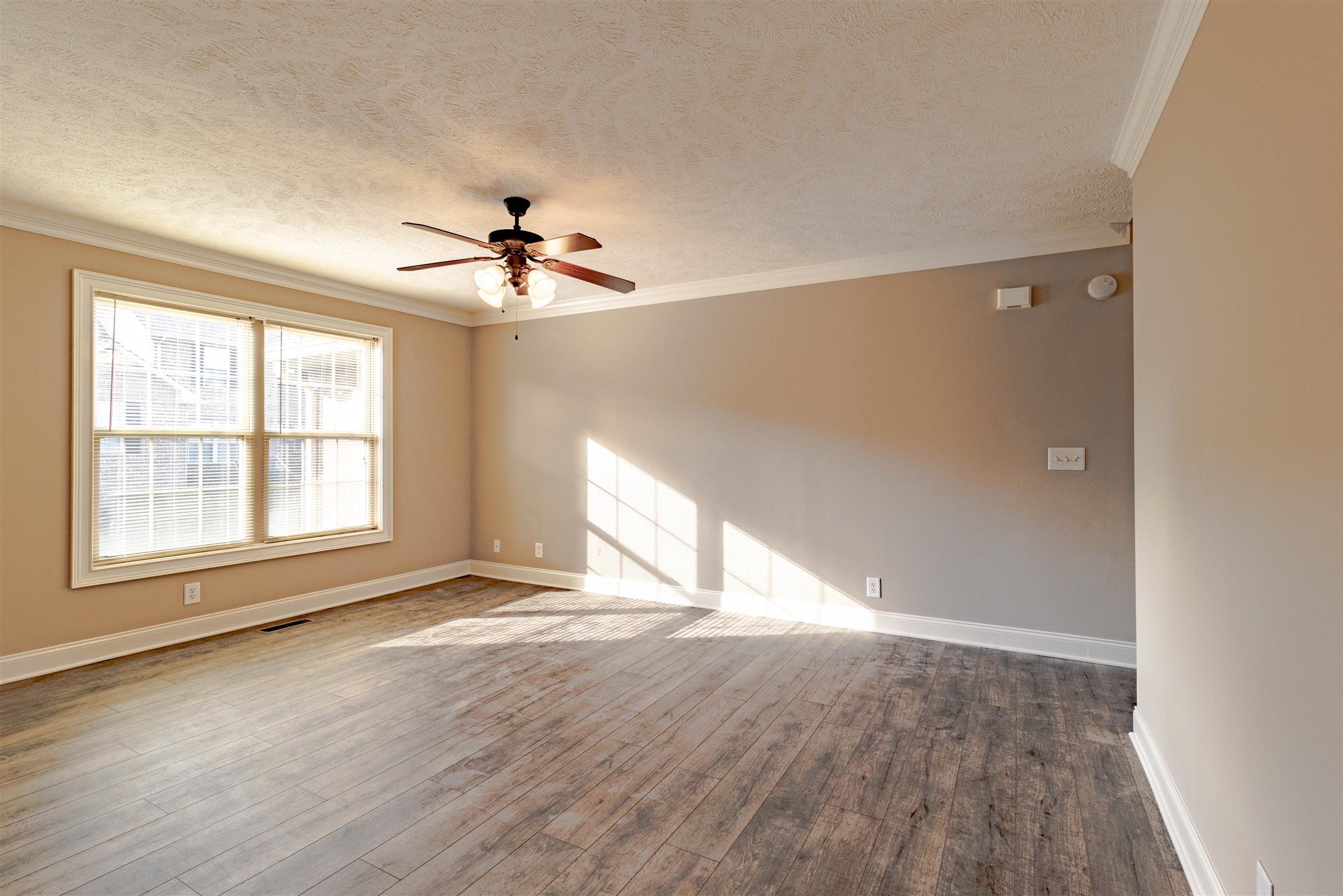 135 Excell Road, Unit 1002 Clarksville, TN 37043 - Photo 4 of 24 wooden floor in an empty room with a window
