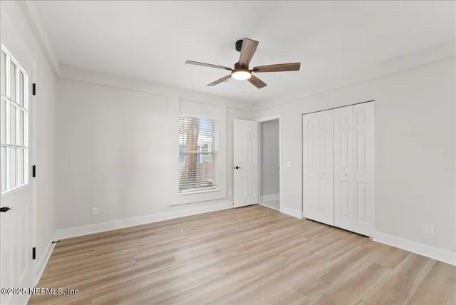 a front view of house with yard and trees in the background