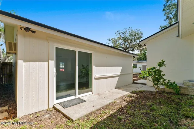 a view of a patio with a table and chairs