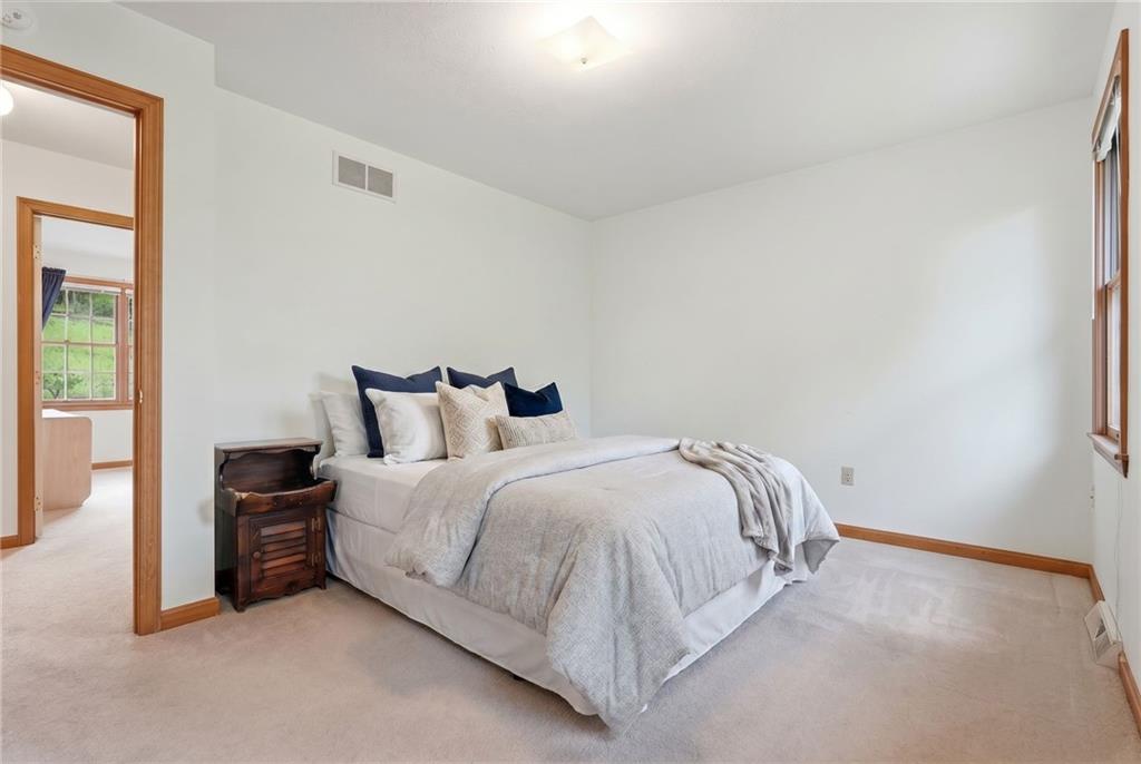 114 Sika Drive Pittsburgh, PA 15239 - Photo 31 of 45 a spacious bedroom with a bed and a mirror