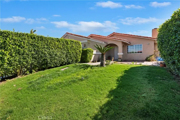 a backyard of a house with lots of green space and garden