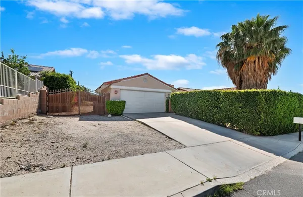 a view of a house with a yard and plant