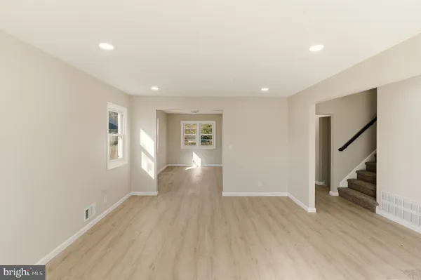 a kitchen with a refrigerator sink and cabinets