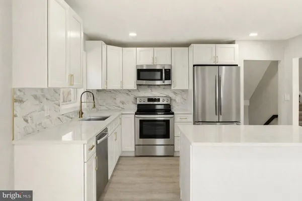 a kitchen with a sink stove and cabinets