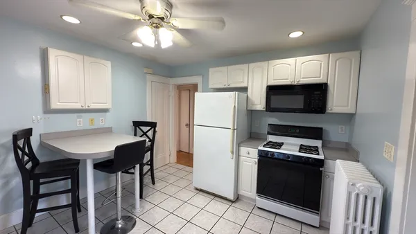 a kitchen with stainless steel appliances a stove a sink refrigerator and a refrigerator