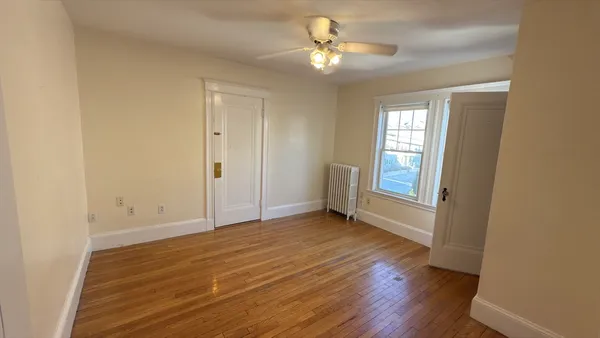 wooden floor in an empty room with a window