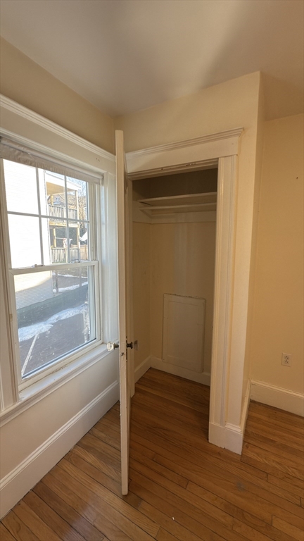 56 Union Street, Unit 2 Boston, MA 02135 - Photo 14 of 17 an empty room with wooden floor and windows