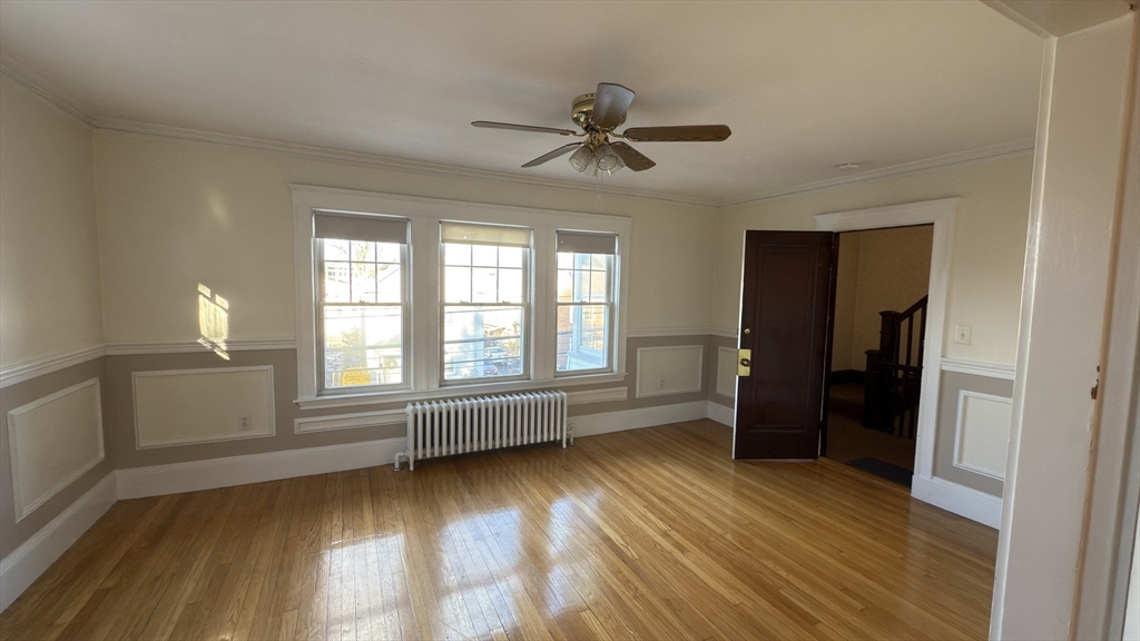 56 Union Street, Unit 2 Boston, MA 02135 - Photo 4 of 17 wooden floor in an empty room with a window