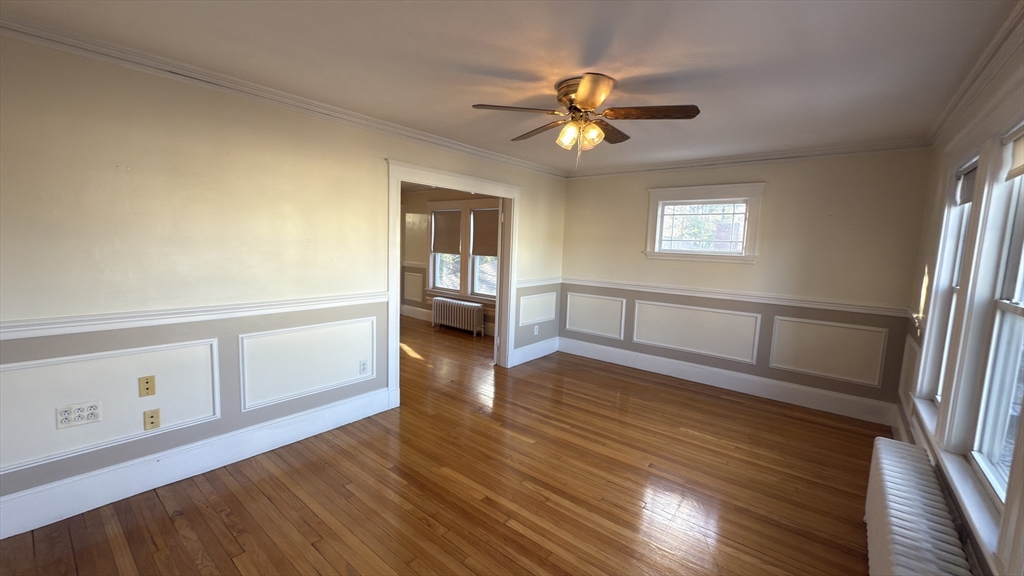 56 Union Street, Unit 2 Boston, MA 02135 - Photo 7 of 17 a view of a livingroom with wooden floor and a ceiling fan
