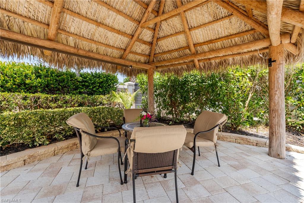 13419 Snook Circle Naples, FL 34114 - Photo 14 of 34 a patio with yard glass top table and chairs