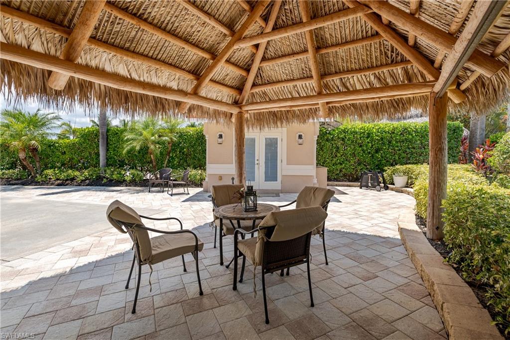 13419 Snook Circle Naples, FL 34114 - Photo 15 of 34 a view of a patio with table and chairs and potted plants
